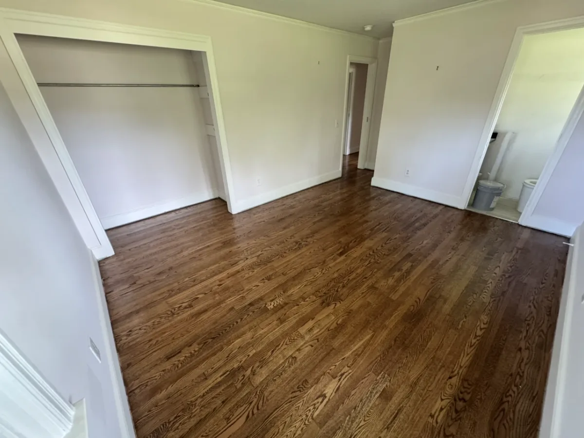 The same bedroom floor after refinishing, deep and even