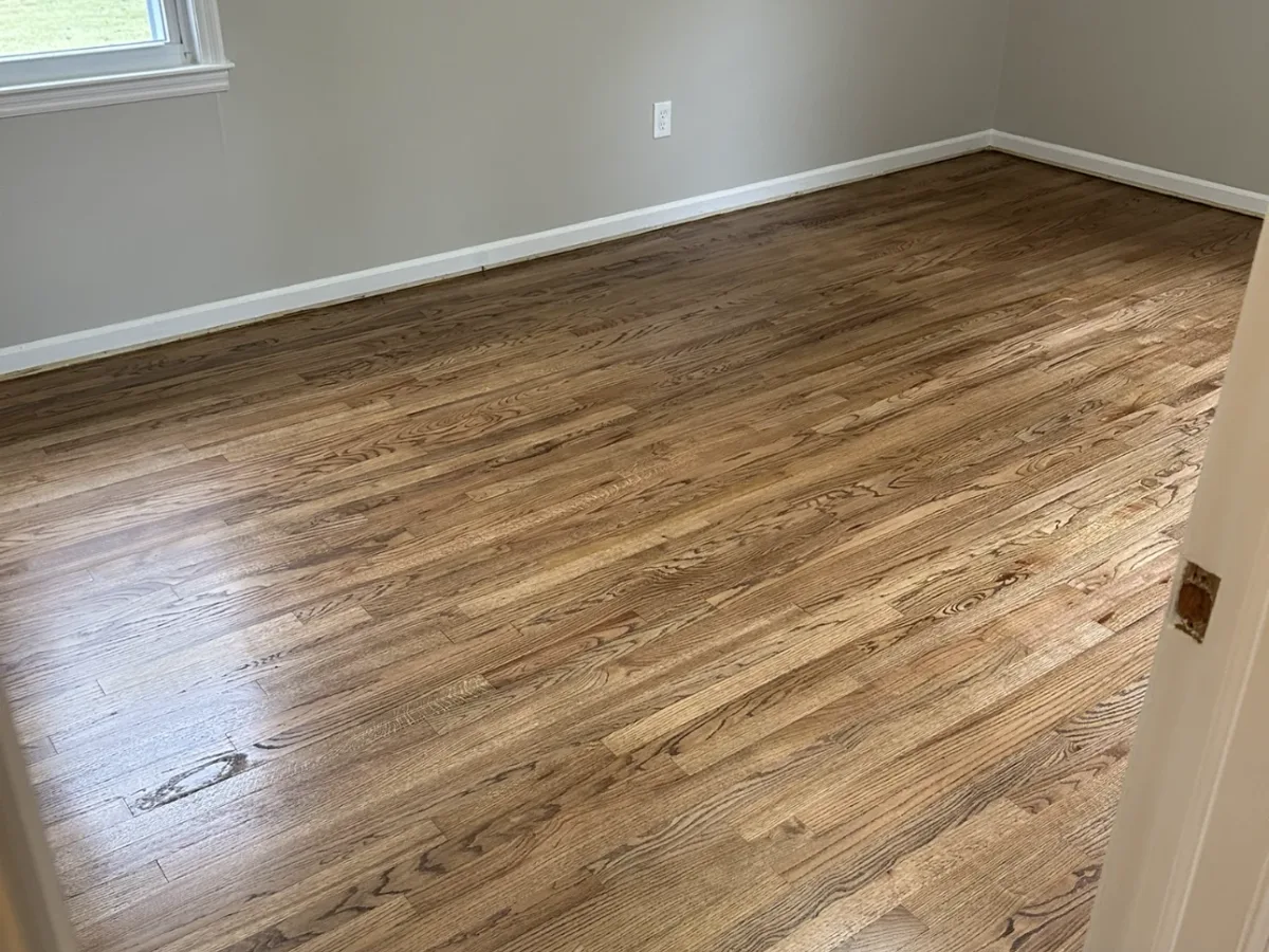 The same oak bedroom floor after sanding and a fresh finish